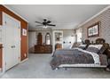Spacious main bedroom featuring patterned wallpaper, ceiling fan, and a vanity at 426 Oakwood Dr, Indianapolis, IN 46260