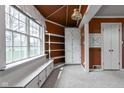 Cozy sunroom with bright windows, built-in bench seating, and ample storage space at 426 Oakwood Dr, Indianapolis, IN 46260