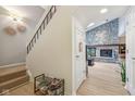 Inviting entryway with staircase, stone fireplace, and modern flooring at 43 Dominion Dr, Zionsville, IN 46077