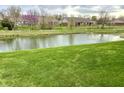 Scenic view of a pond with lush green surroundings in a peaceful community setting, perfect for nature lovers at 4327 Switchgrass Way, Indianapolis, IN 46237