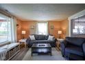 Inviting living room with hardwood floors, modern furniture, and large window at 502 N Maple St, Ingalls, IN 46048