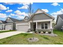 Beautiful home exterior showcasing a manicured lawn, a covered porch, and craftsman-style architecture at 5309 Spyglass Dr, Whitestown, IN 46075
