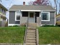 Front view of a gray home featuring a brick porch with a set of concrete steps at 59 N Ridgeview Dr, Indianapolis, IN 46219