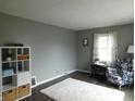 Bright living room featuring neutral gray walls and a white shag rug on modern wood flooring at 59 N Ridgeview Dr, Indianapolis, IN 46219