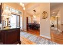 Elegant foyer with hardwood floors, a stylish rug, and views of the dining room at 6081 Boulder Ct, Columbus, IN 47201