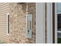 Close-up showcasing the building's exterior brick, intercom and numbered condo units at 6516 Emerald Hill Ct # 310, Indianapolis, IN 46237