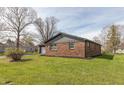 A charming brick house sits on a lush green lawn, showcasing its simple beauty at 652 E Tilden Dr, Brownsburg, IN 46112