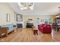 Bright living room featuring skylights, hardwood floors, a fireplace, and comfortable seating area at 7450 Deville Ct, Indianapolis, IN 46256