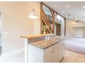 Bright, modern kitchen with a granite counter island with seating, pendant lighting, and open floorplan at 7748 S State Road 39, Clayton, IN 46118