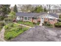 An elevated view of a brick home showing the driveway, lawn, and well-maintained landscaping at 80 S Richland Ave, Carmel, IN 46032
