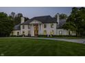 Elegant two-story home with a grand entrance, beautiful columns and a well-manicured lawn at 8155 Hunt Club Rd, Zionsville, IN 46077