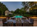 Stunning outdoor pool with a dining table and chairs for entertaining guests at 8155 Hunt Club Rd, Zionsville, IN 46077