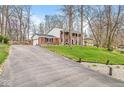 A long driveway leads to this home with a brick and siding exterior, complete with an attached garage at 8715 Kensington Dr, Noblesville, IN 46060