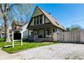 Charming two-story home featuring a steeply pitched roof and inviting front porch at 933 Tecumseh St, Indianapolis, IN 46201