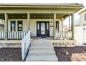 Inviting front porch with stone steps leading to the home's entrance at 933 Tecumseh St, Indianapolis, IN 46201