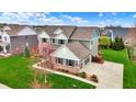 Beautiful two-story home with a well-maintained lawn and a cozy front porch at 10235 Normandy Way, Fishers, IN 46040