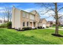 Beautifully landscaped yard surrounds a two-story brick home with a side-entry two-car garage at 12027 Sellerton Dr, Fishers, IN 46037