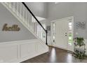 Bright foyer featuring hardwood floors, a staircase with white banister, and natural light at 12027 Sellerton Dr, Fishers, IN 46037