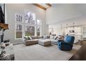 Cozy living room with a soaring ceiling, fireplace, large windows, and an open floor plan at 12598 Coastal Pl, Fishers, IN 46037