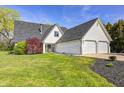 Beautiful home with a well-maintained lawn, featuring white siding and a two-car garage at 138 Fairway Dr, Indianapolis, IN 46260