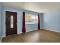 Inviting living room features a large window, modern flooring, and a stylish front door at 1457 Biloxi Ln, Beech Grove, IN 46107