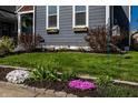 Lush front yard featuring vibrant flowers and well-maintained green grass at 1626 S Delaware St, Indianapolis, IN 46225