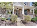 Inviting front porch with brick columns, white railings, and a stylish front door at 16994 Folly Brook Rd, Noblesville, IN 46060