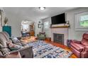 Inviting living room features a fireplace, hardwood floors, and views of the dining area at 1917 W 58Th St, Indianapolis, IN 46228