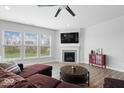 Comfortable living room showcasing a fireplace, ample natural light, and a modern design at 19283 Donelson Ln, Westfield, IN 46062
