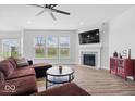 Stylish living room featuring a cozy fireplace, large windows, and modern decor at 19283 Donelson Ln, Westfield, IN 46062