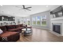 Bright and airy living room featuring a fireplace, large windows, and an open floor plan at 19283 Donelson Ln, Westfield, IN 46062