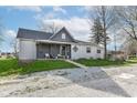 Attractive home featuring a welcoming front porch and a well-maintained exterior, sitting on a gravel lot at 2001 S I St, Elwood, IN 46036