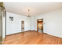 Bright living room featuring hardwood floors and white walls, lit by a vintage chandelier at 2001 S I St, Elwood, IN 46036