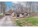 Home with detached garage and long driveway bordered by mature trees at 2088 Brandywine Ln, Martinsville, IN 46151