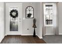Bright entryway featuring a decorative front door, stylish mirror, and neutral decor at 241 Green Meadow Dr, Indianapolis, IN 46229