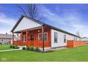 Beautifully renovated home with a fresh exterior and lush green lawn at 2428 N Gale St, Indianapolis, IN 46218