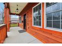 Close-up of a charming porch with updated features, lighting, and detailed woodwork at 2428 N Gale St, Indianapolis, IN 46218