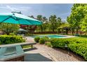 Pool area featuring blue umbrella with outdoor kitchen, perfect for summer entertaining at 290 Breakwater Dr, Fishers, IN 46037