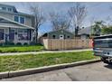 View of a home with a new privacy fence, situated on a well-maintained lot with green grass at 334 N Chester Ave, Indianapolis, IN 46201