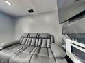 Comfortable living room showcasing a plush gray sofa and a stylish fireplace with white surround at 334 N Chester Ave, Indianapolis, IN 46201