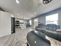 An open-concept living room with modern furniture, gray walls, and gray flooring at 334 N Chester Ave, Indianapolis, IN 46201