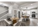 Open-concept kitchen with white cabinets, stainless steel appliances, and a dining area with chairs at 341 Sanders St, Indianapolis, IN 46225