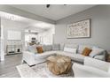Open-concept living room with gray walls, light wood floors, a sectional couch, and decoratively patterned area rug at 341 Sanders St, Indianapolis, IN 46225