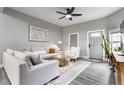 Open-concept living room with gray walls, light wood floors, a sectional couch, and modern decor at 341 Sanders St, Indianapolis, IN 46225