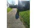 View of a driveway leading up to a house with a garage in the background at 3505 N Layman Ave, Indianapolis, IN 46218