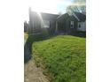 A cozy home with a chimney, tidy lawn, and a neatly paved driveway at 3505 N Layman Ave, Indianapolis, IN 46218