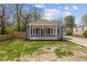 Charming bungalow with gray siding, crisp white trim, and a cozy front porch at 3624 Wallace Ave, Indianapolis, IN 46218