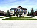 Charming two-story home with a well-manicured lawn, lush landscaping, and a welcoming curb appeal at 4414 Hickory Grove Blvd, Greenwood, IN 46143