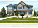 A two-story home with brick and siding, complemented by green grass and sidewalk at 4414 Hickory Grove Blvd, Greenwood, IN 46143