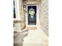 A charming front door adorned with a flower wreath and a warm, inviting ambiance at 4414 Hickory Grove Blvd, Greenwood, IN 46143